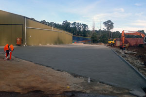 Large commercial conrete slab used as driveway around large factory